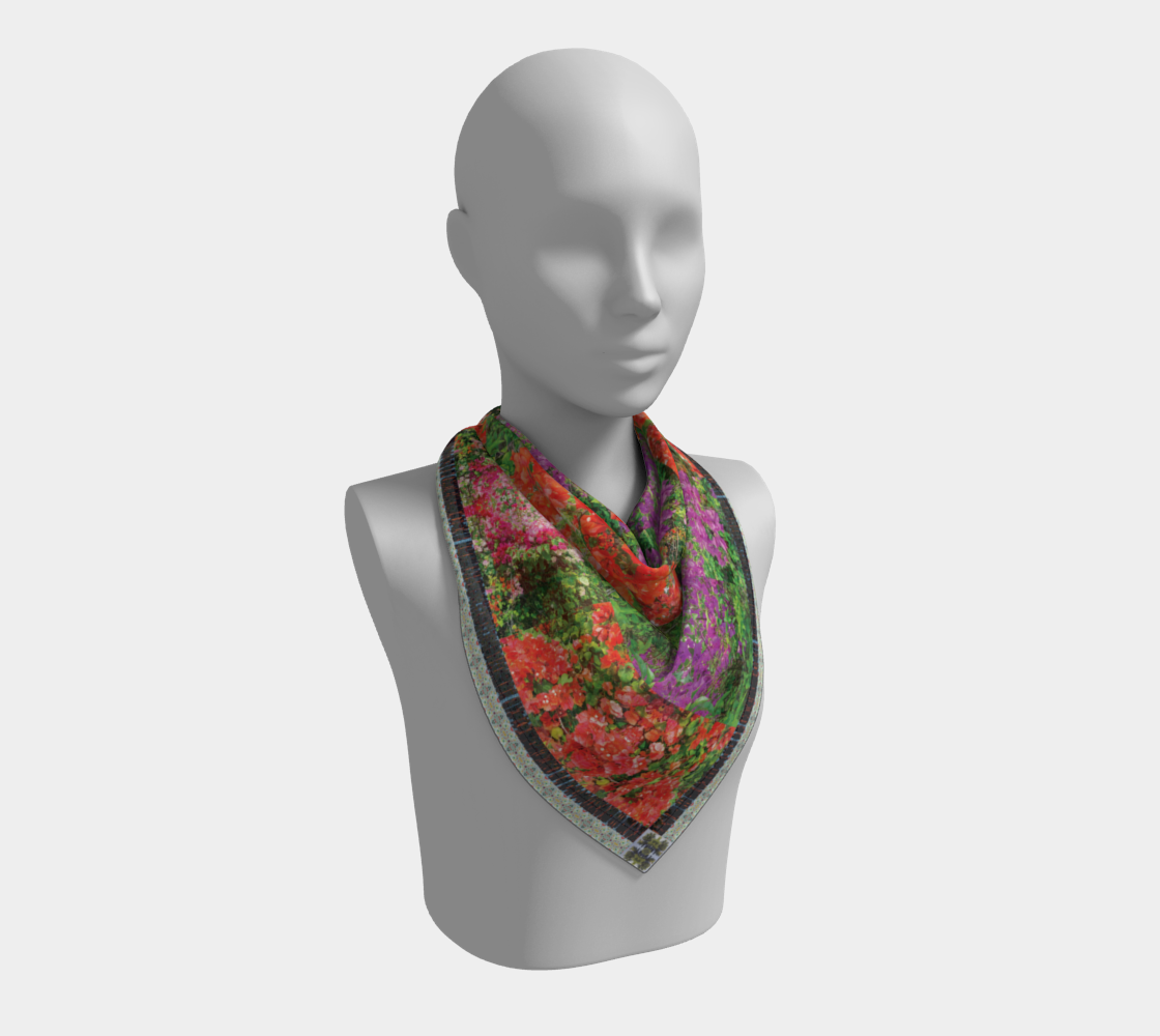 Maui Bloom scarf by Leeloo + Zohan draped on a mannequin, showcasing its colorful patterns and elegant silk material.