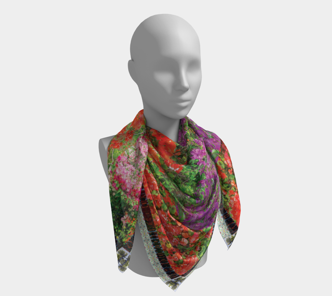 Maui Bloom scarf by Leeloo + Zohan elegantly styled on a mannequin, featuring bright floral motifs in rich colors.